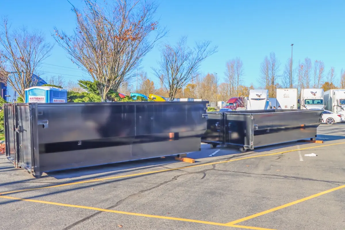 Professional dumpster rental service with roll-off container on residential driveway in Larkin